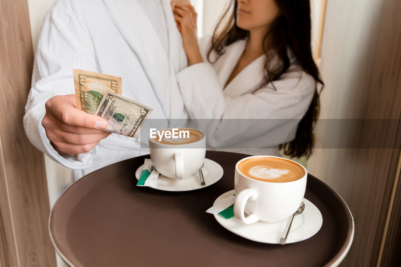 Room service serving coffee to customer