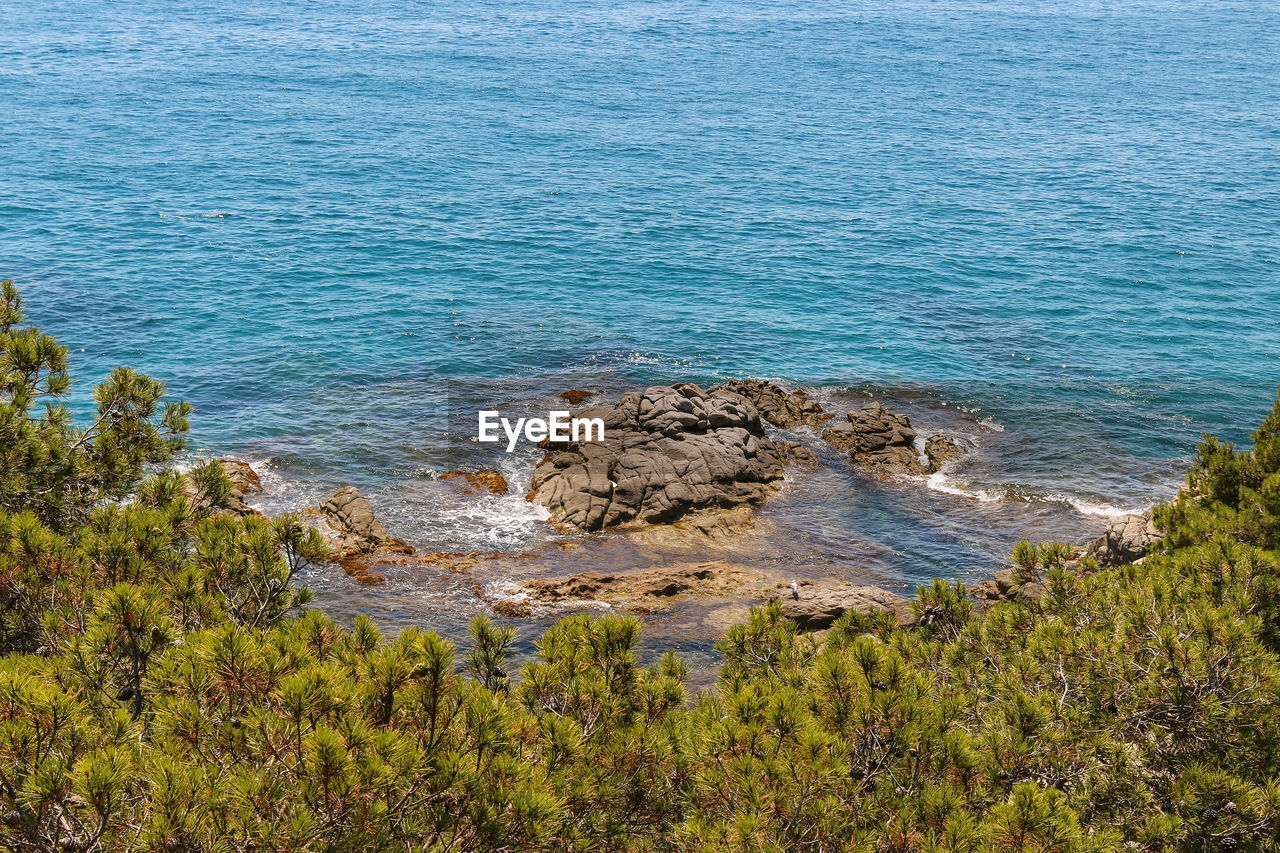 High angle view of rocks by sea