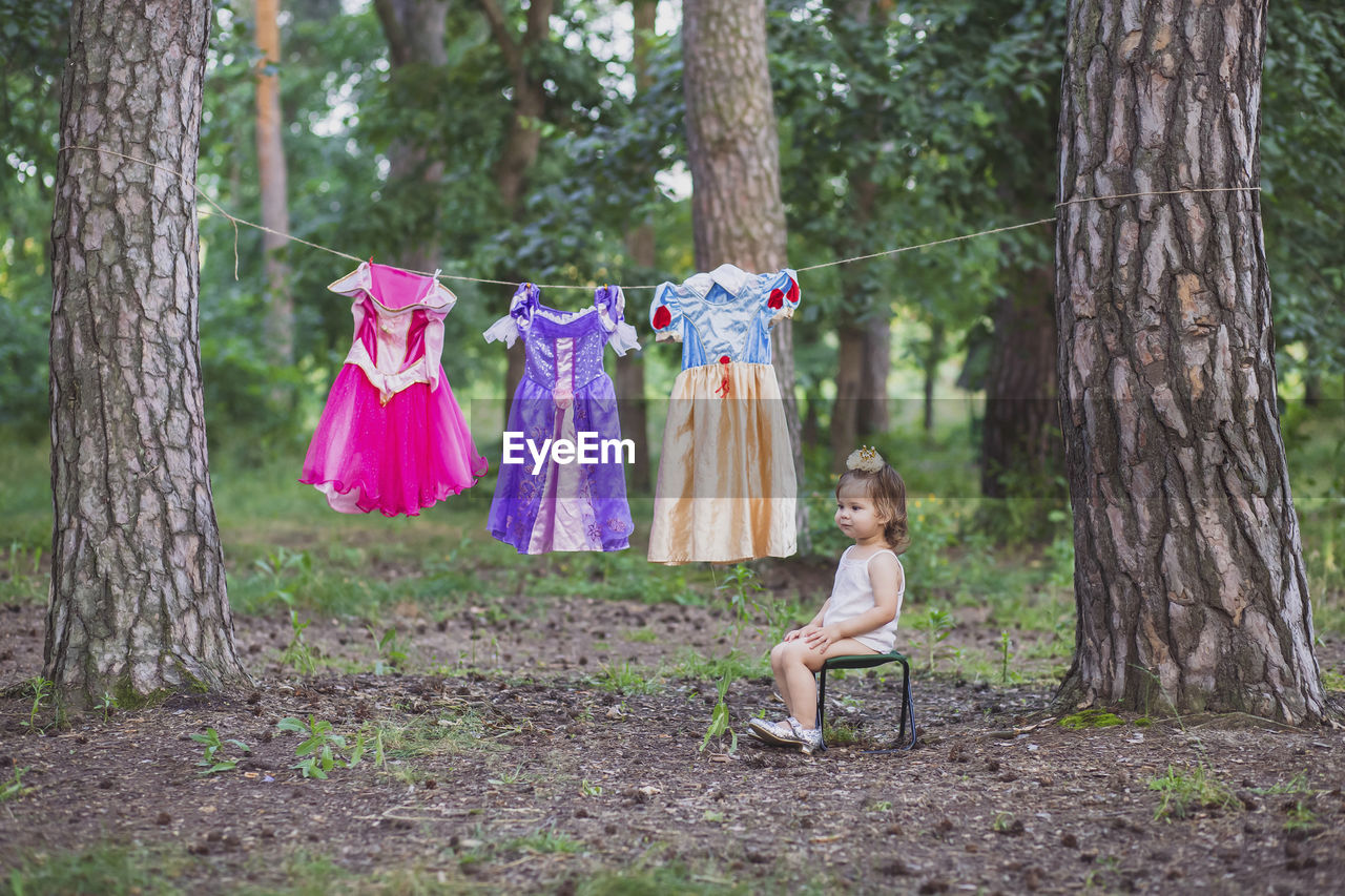 Charming baby hung out princess costumes to dry