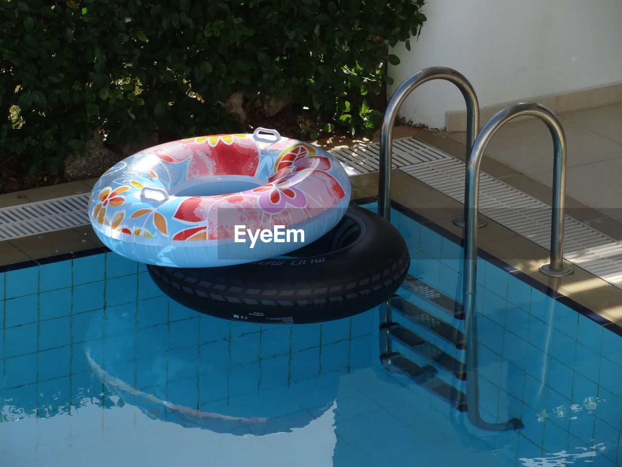 High angle view of inflatable raft floating on swimming pool