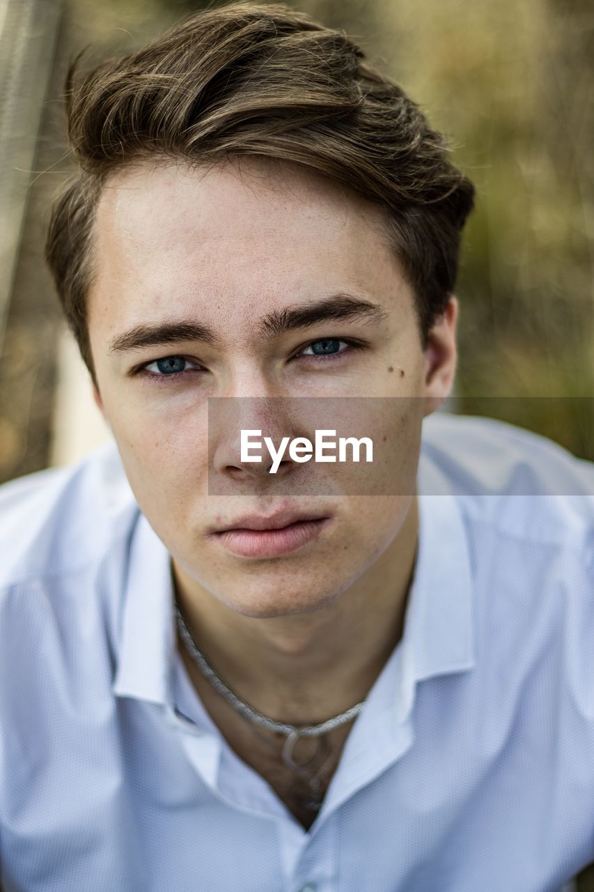 High angle portrait of young man standing outdoors