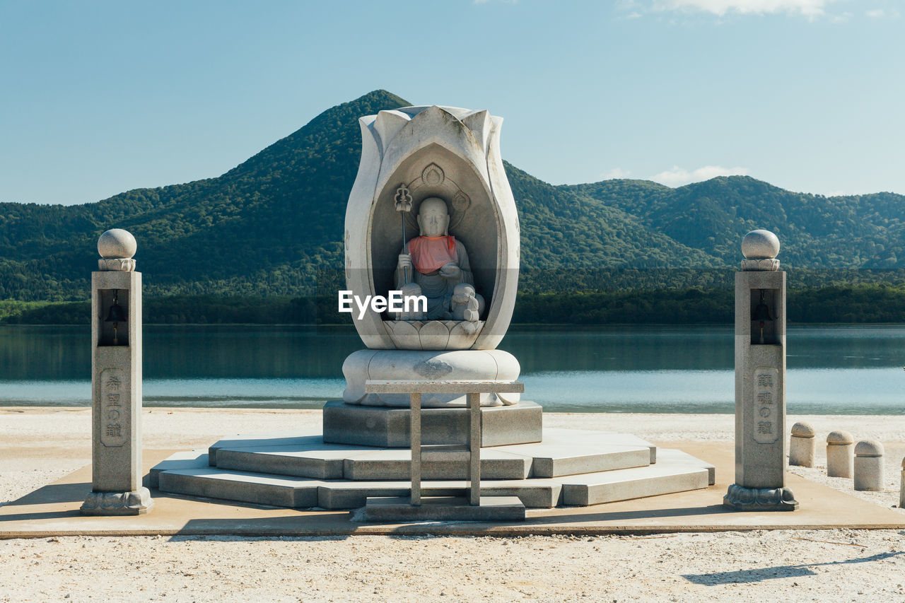 Buddhist monument at edge of lake usori, a scenic spot inside the osore-san bodai-ji temple in japan