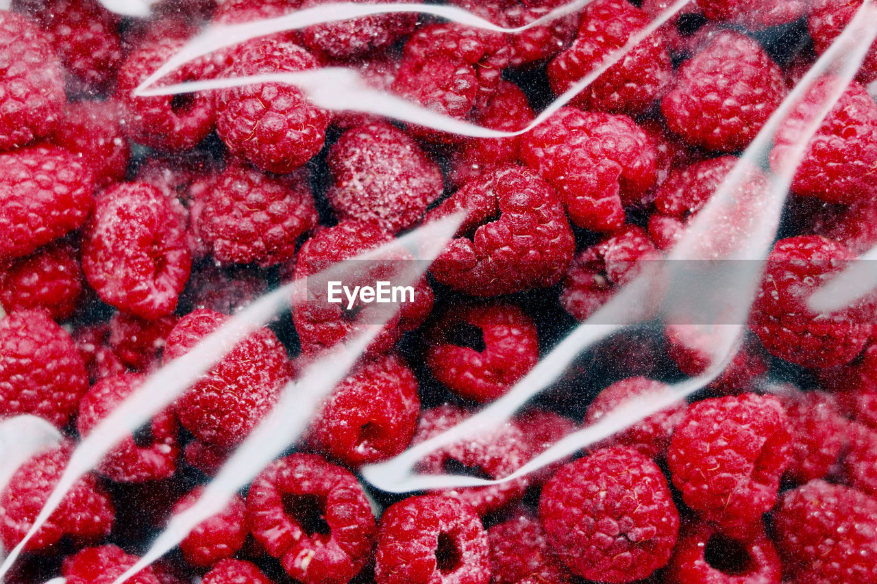 Full frame shot of raspberries in plastic