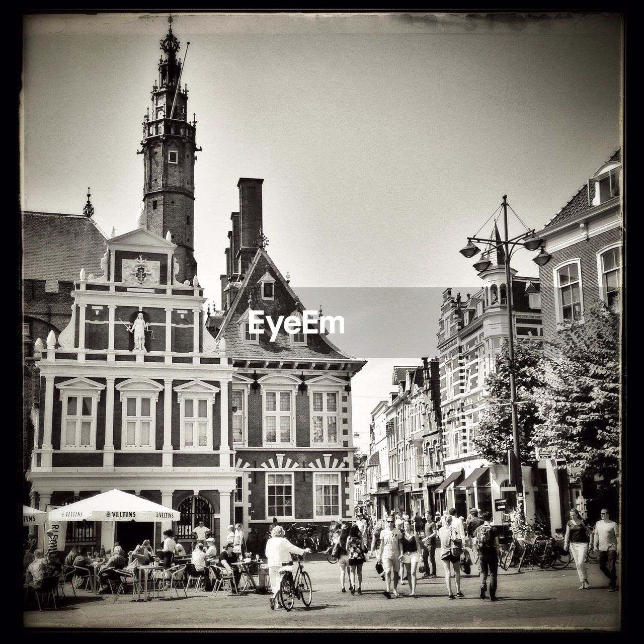 People on city street against buildings