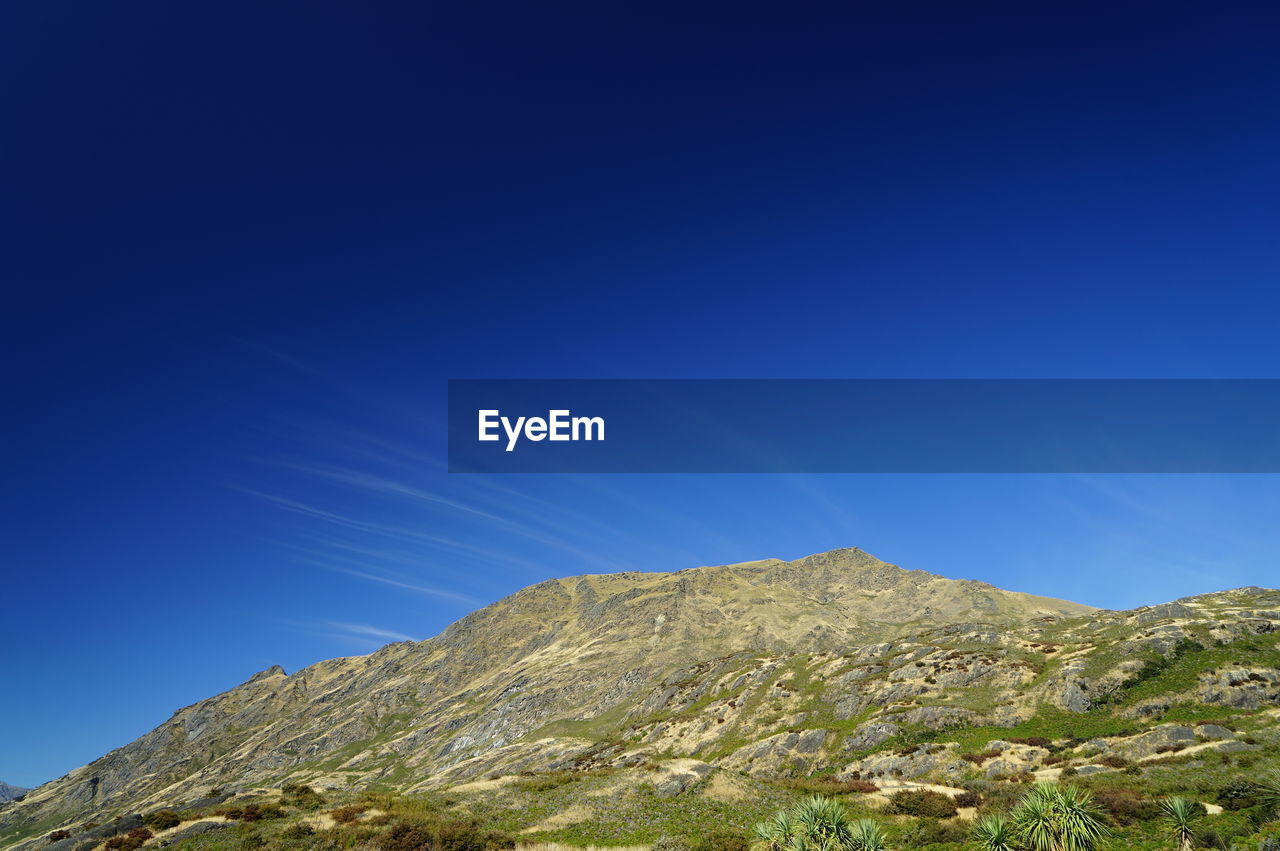 LOW ANGLE VIEW OF MOUNTAIN AGAINST CLEAR SKY