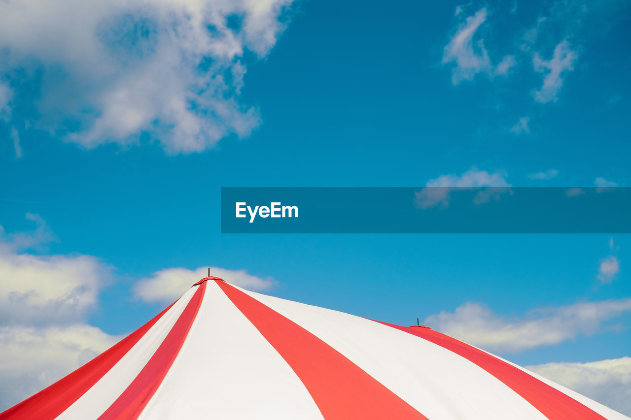 Circus tent under blue sky colorful stripes