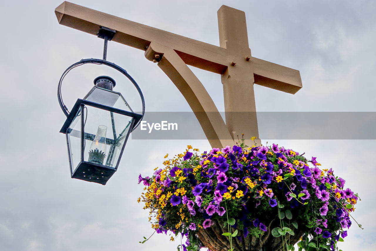 Low angle view of cross against sky