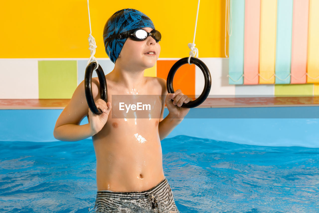 Shirtless boy in swimming pool