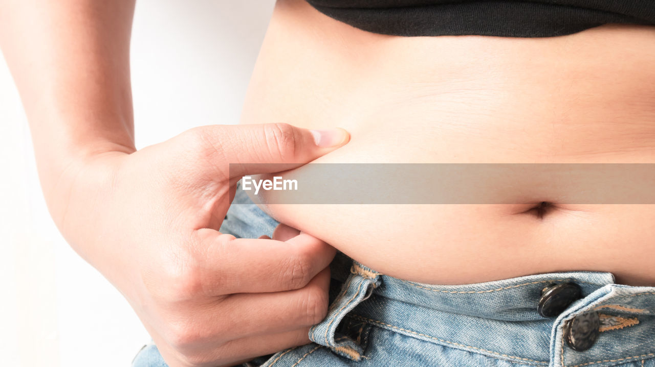 Midsection of woman holding stomach