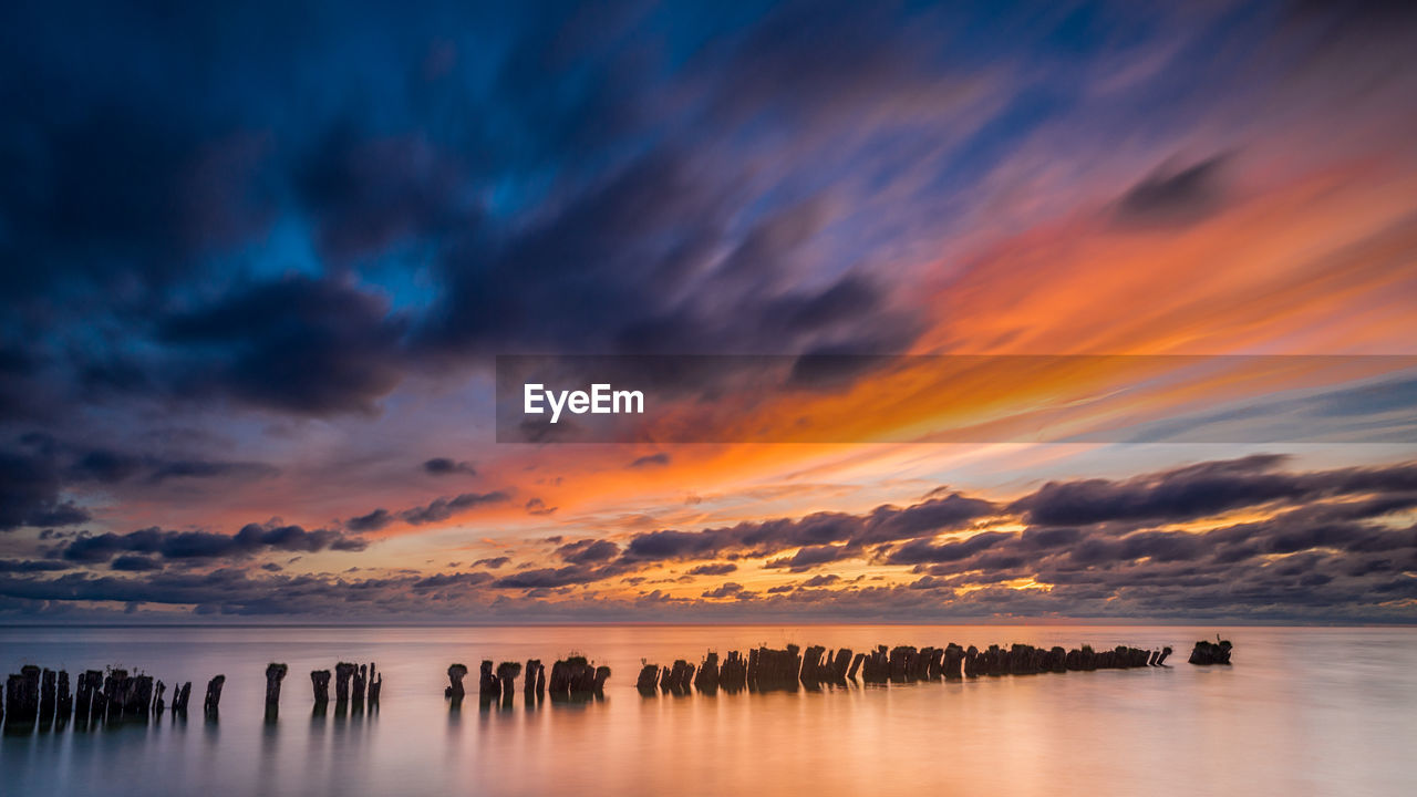 Scenic view of sea against sky at sunset