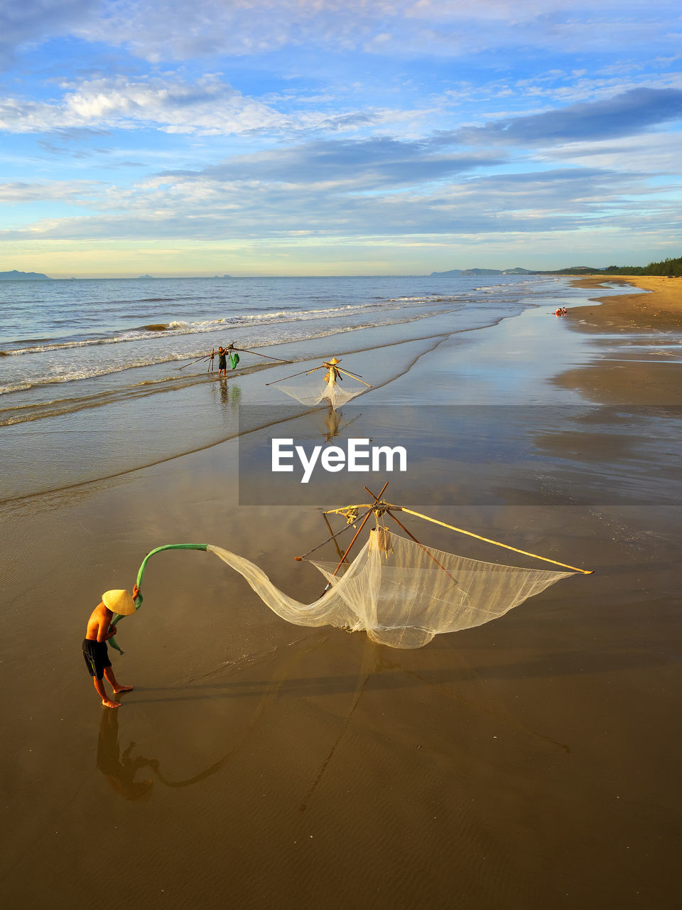 Fishermen working with nets at beach