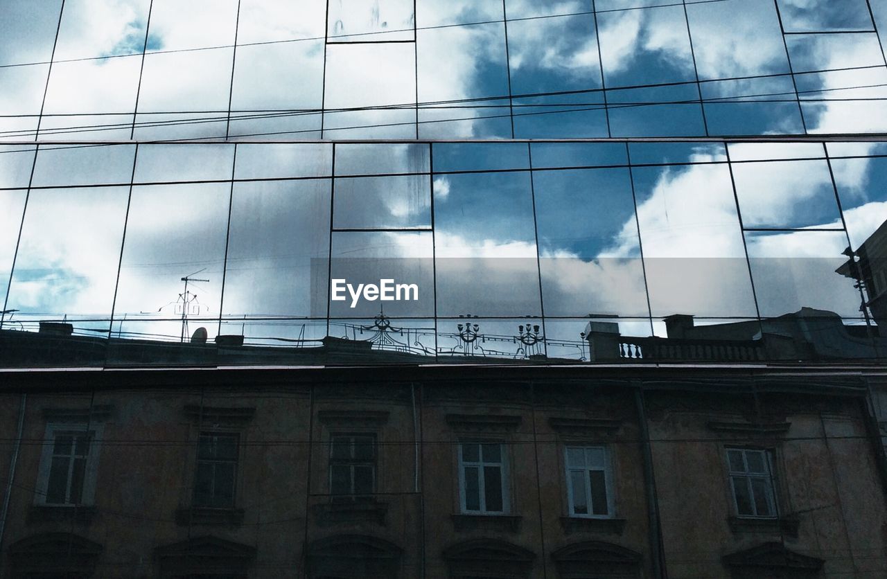 Reflection of building and sky on glass