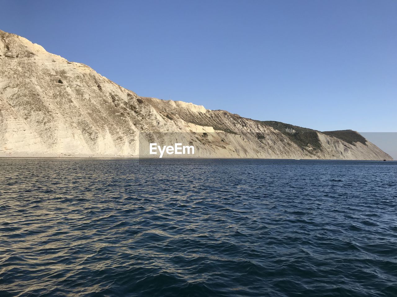 Scenic view of sea against clear blue sky