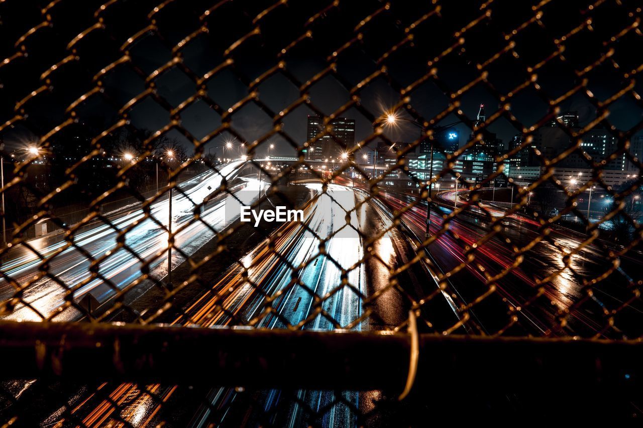 ILLUMINATED CITY AGAINST SKY AT NIGHT