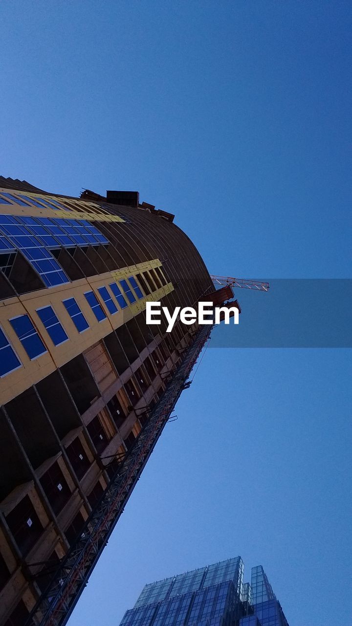 LOW ANGLE VIEW OF BUILDINGS AGAINST CLEAR SKY