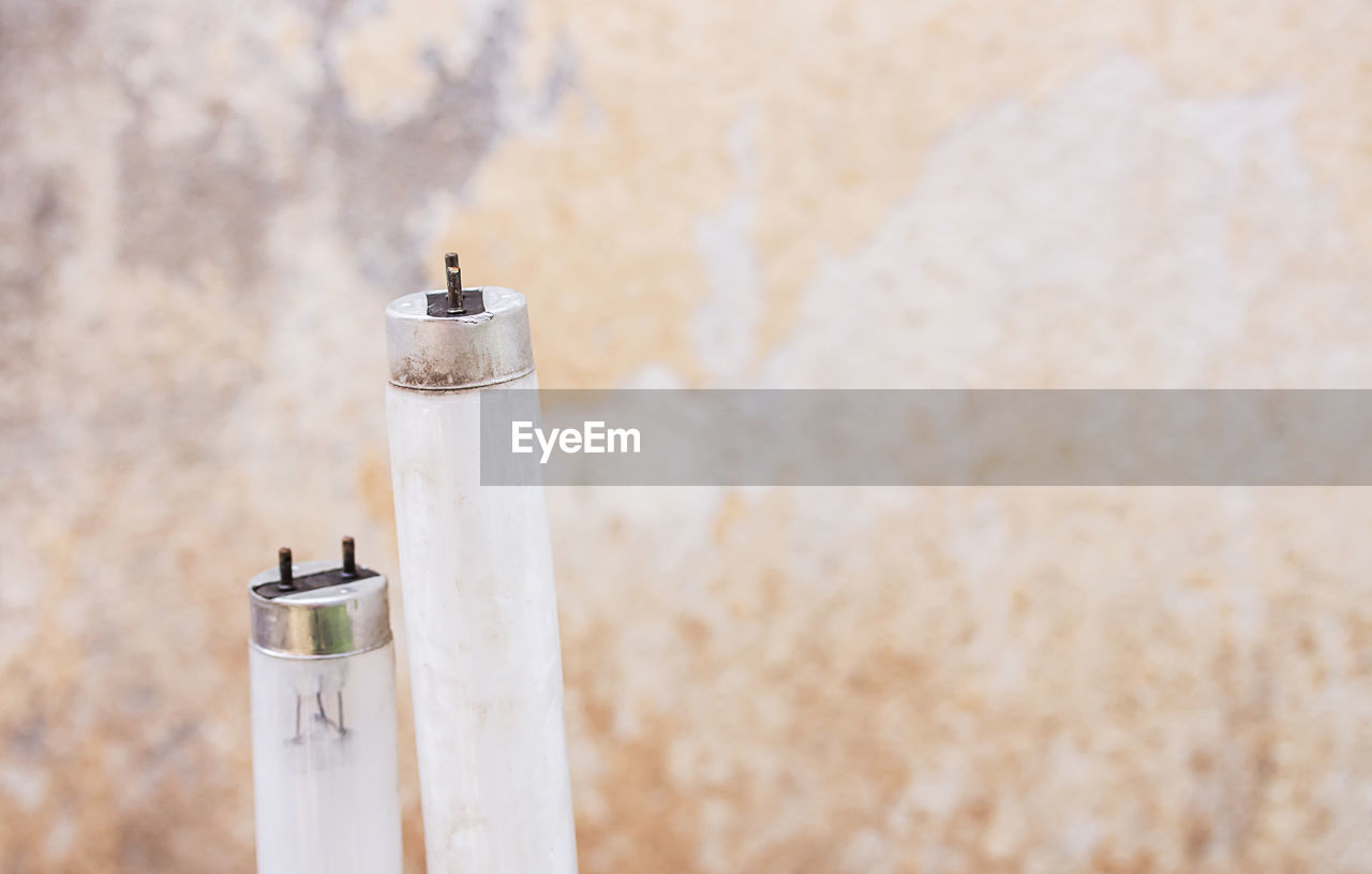 CLOSE-UP OF CIGARETTE AGAINST WALL