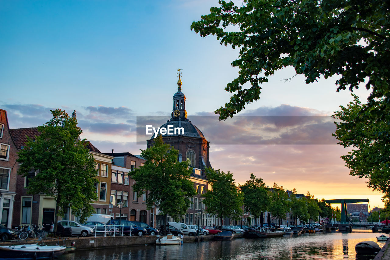 CANAL AMIDST BUILDINGS IN CITY