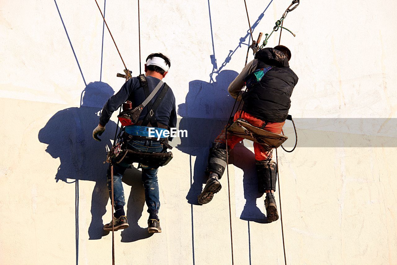 MEN WORKING WITH ROPE