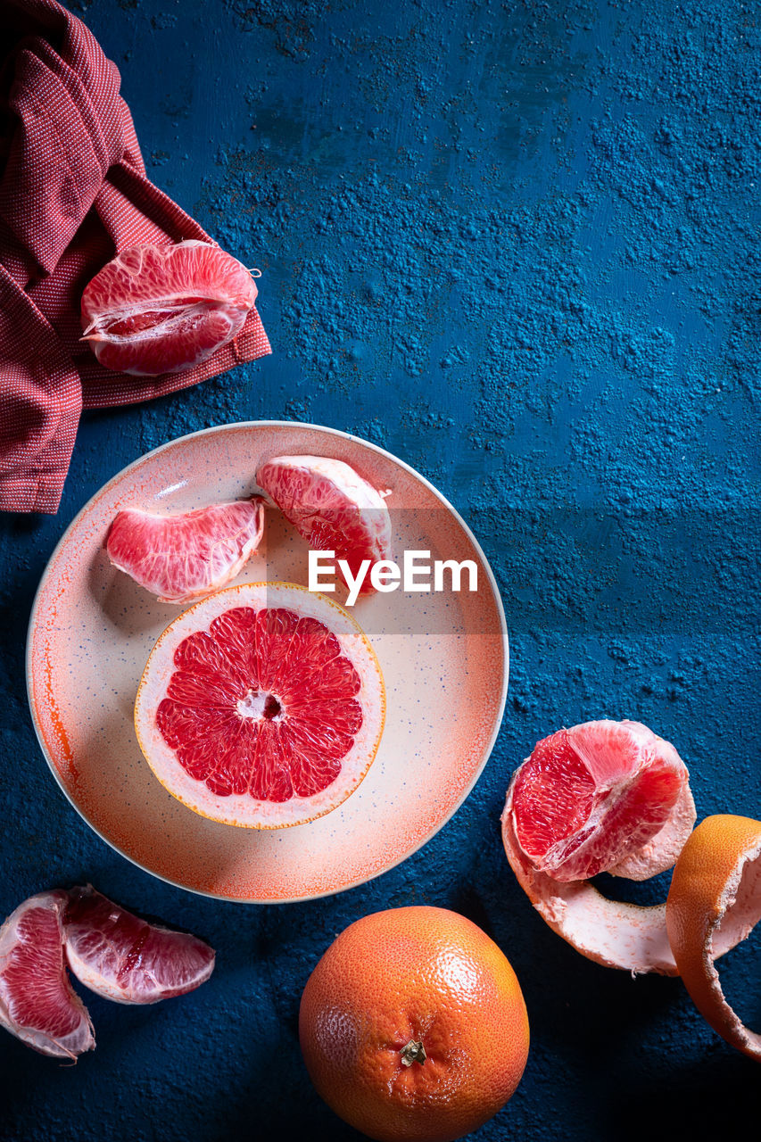 HIGH ANGLE VIEW OF FRUITS AND BLUE TABLE