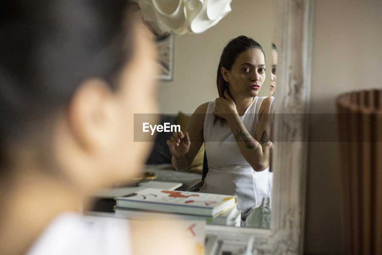 Woman with disability getting ready while looking in mirror at home