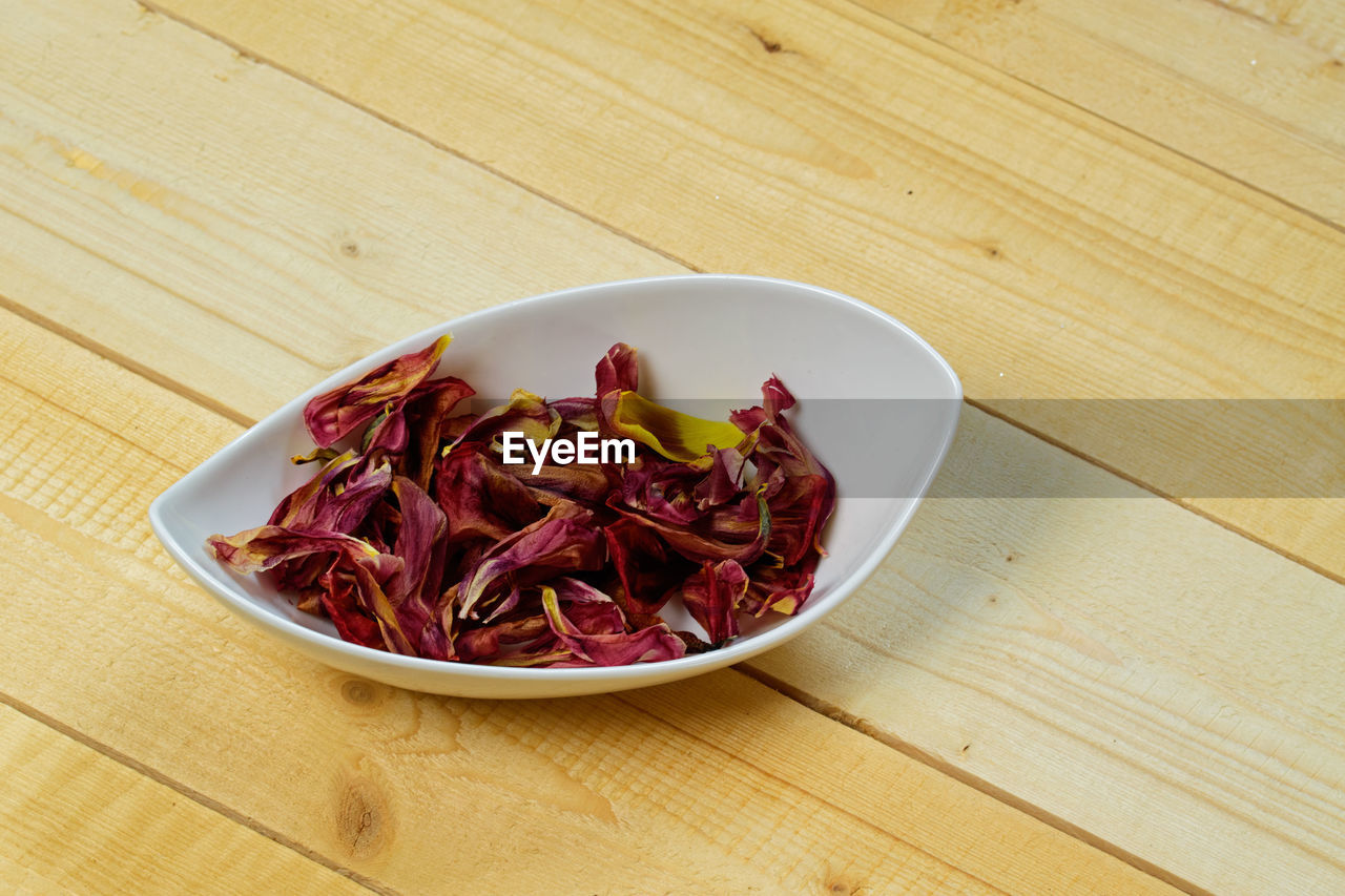 food and drink, food, wellbeing, healthy eating, produce, vegetable, freshness, wood, table, indoors, no people, dish, red, plant, plate, high angle view, dried food, bowl, still life, spice, fruit, crockery