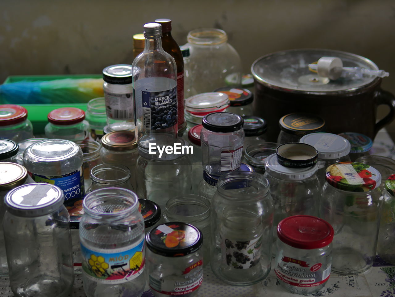 container, large group of objects, no people, bottle, variation, high angle view, indoors, food, meal, water, household equipment, glass, still life, food and drink, mason jar, abundance, drink, table