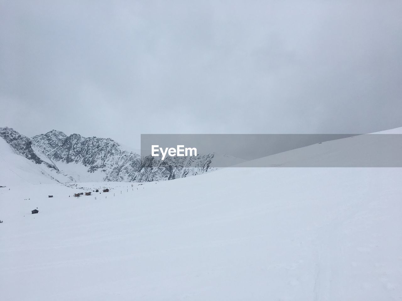 SNOW COVERED LANDSCAPE AGAINST SKY