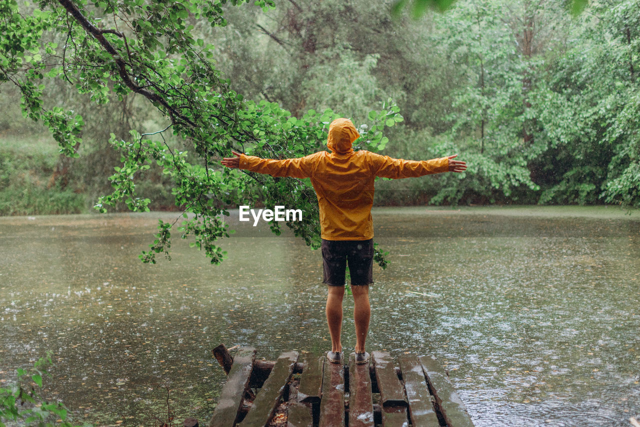 FULL LENGTH OF BOY STANDING IN LAKE