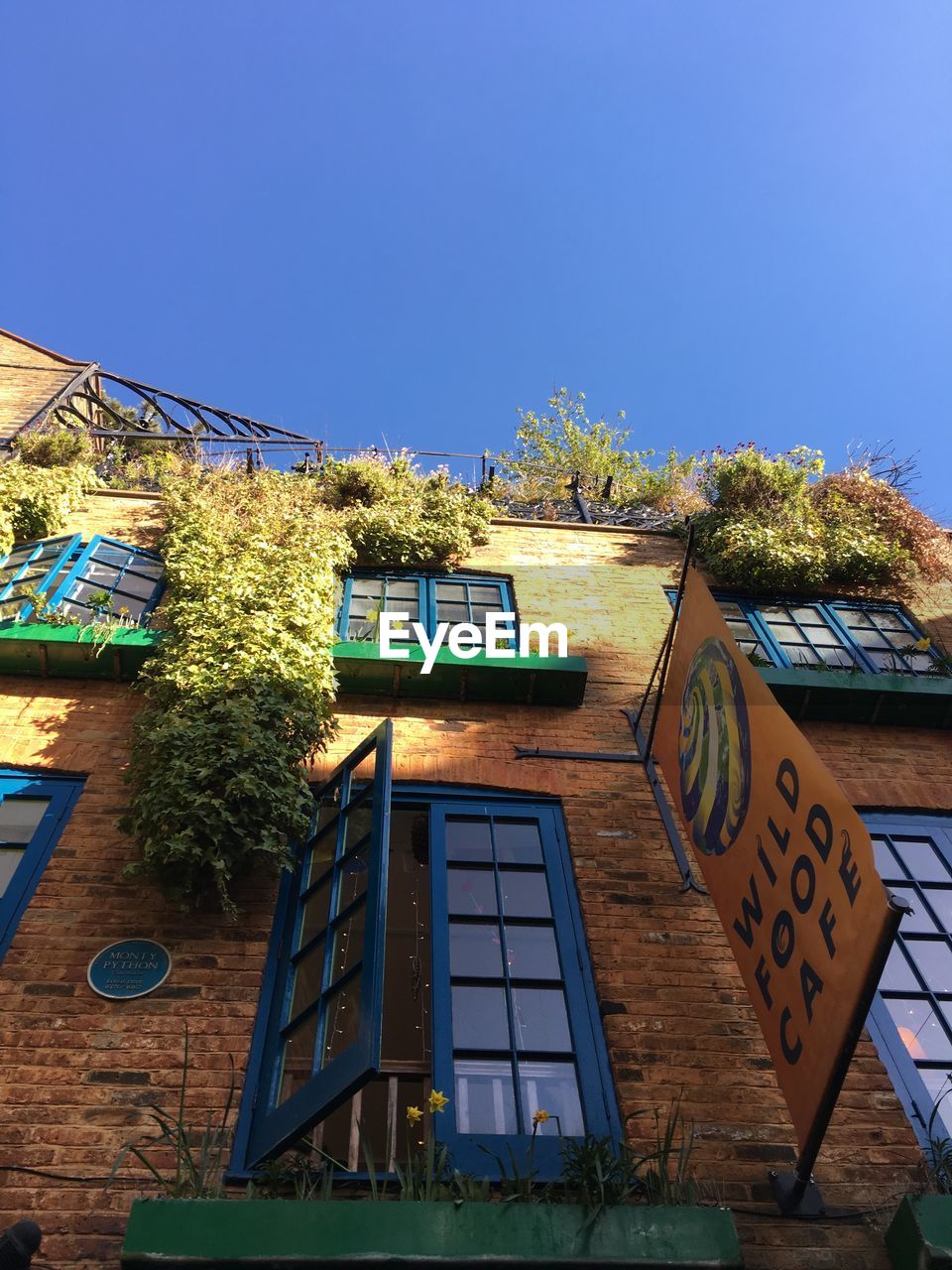 LOW ANGLE VIEW OF BUILT STRUCTURES AGAINST CLEAR BLUE SKY