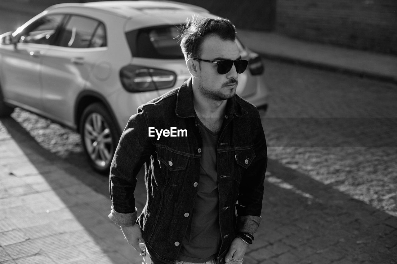 Young man wearing sunglasses on street