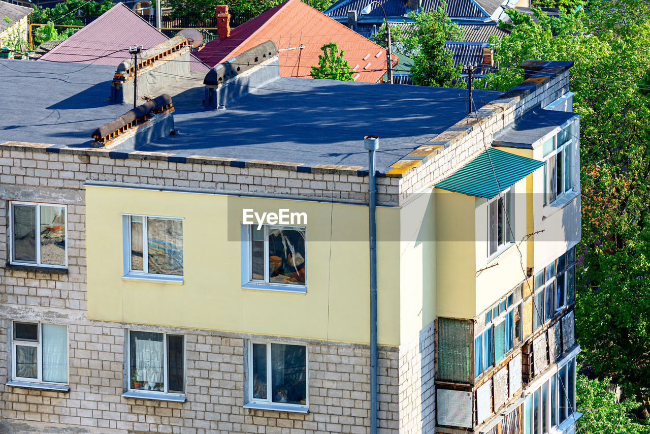 Thermal insulation of an apartment with polystyrene foam  . bituminous roof with chimney