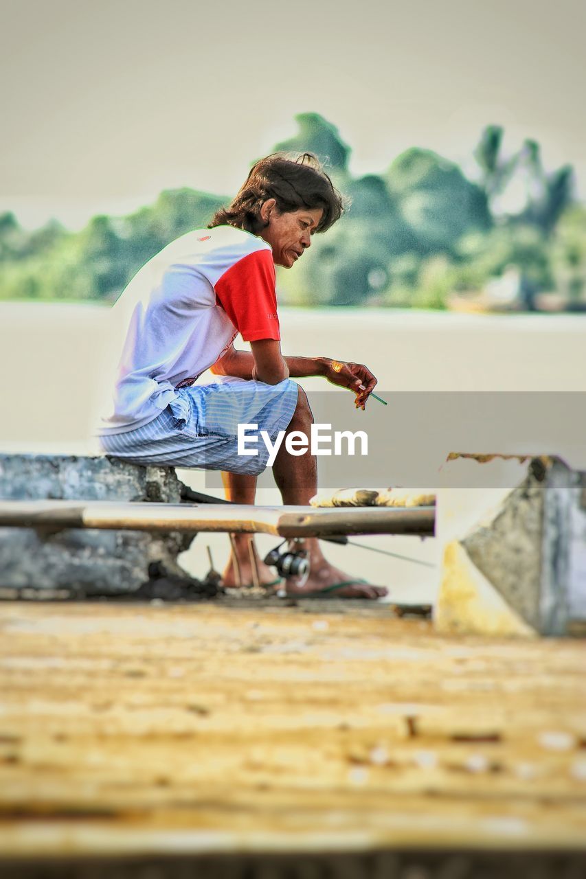 FULL LENGTH OF A BOY PLAYING ON WOODEN TABLE