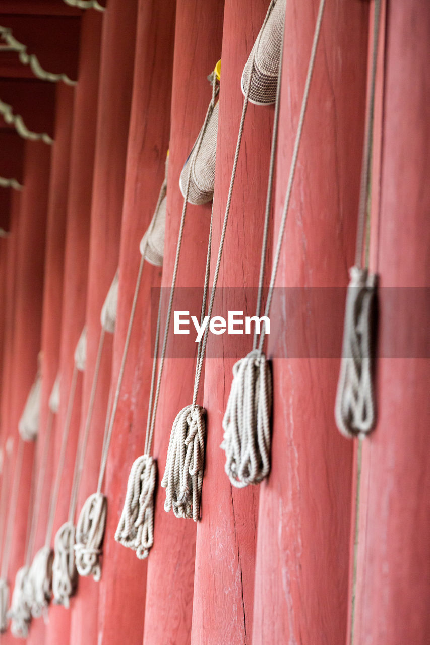 CLOSE-UP OF CLOTHES HANGING ON BUILT STRUCTURE