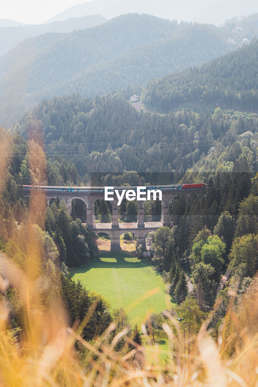 View of the kalte rinne railway viaduct and a passing train in semmering, rax-schneeberg, austria