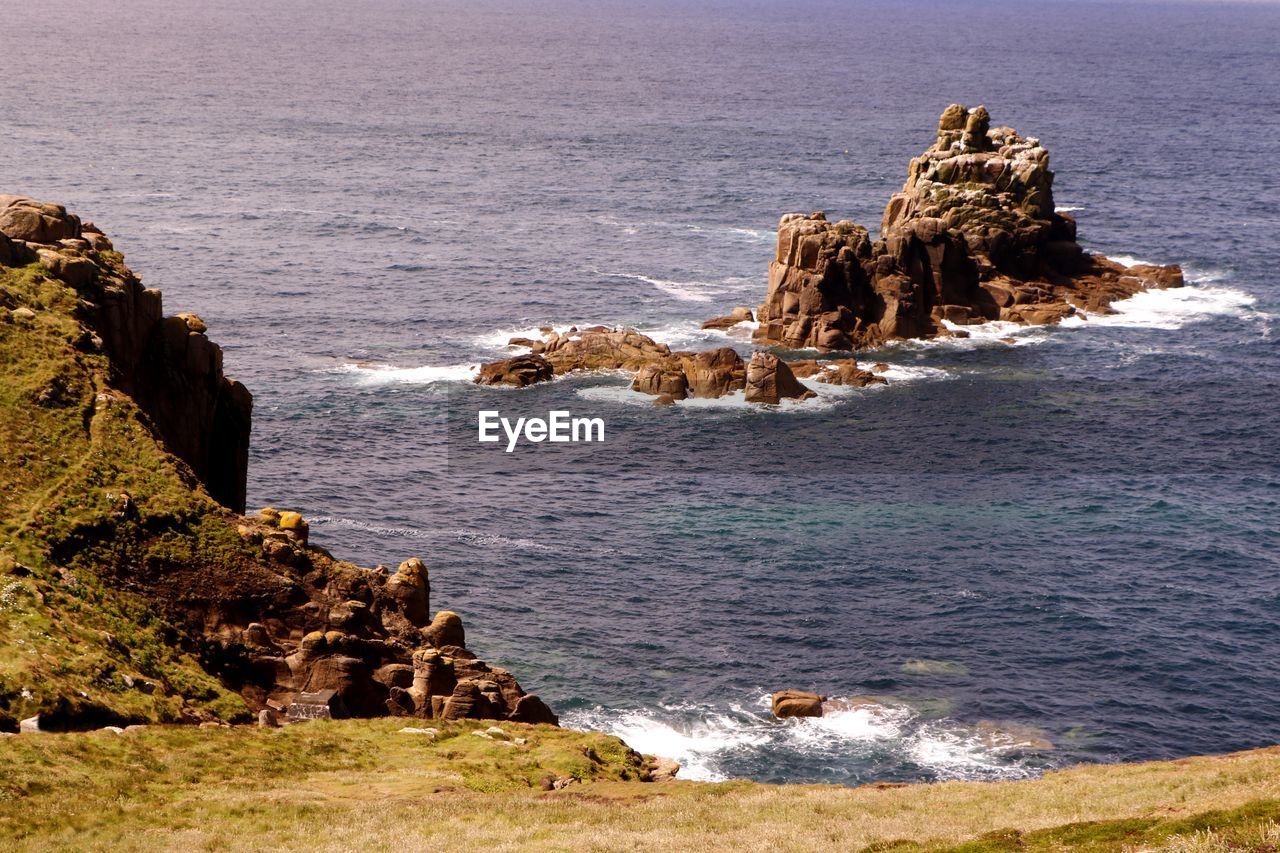 Rock formations by sea against sky