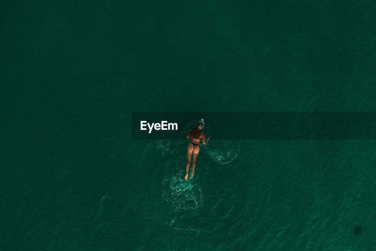 high angle view of man jumping in sea