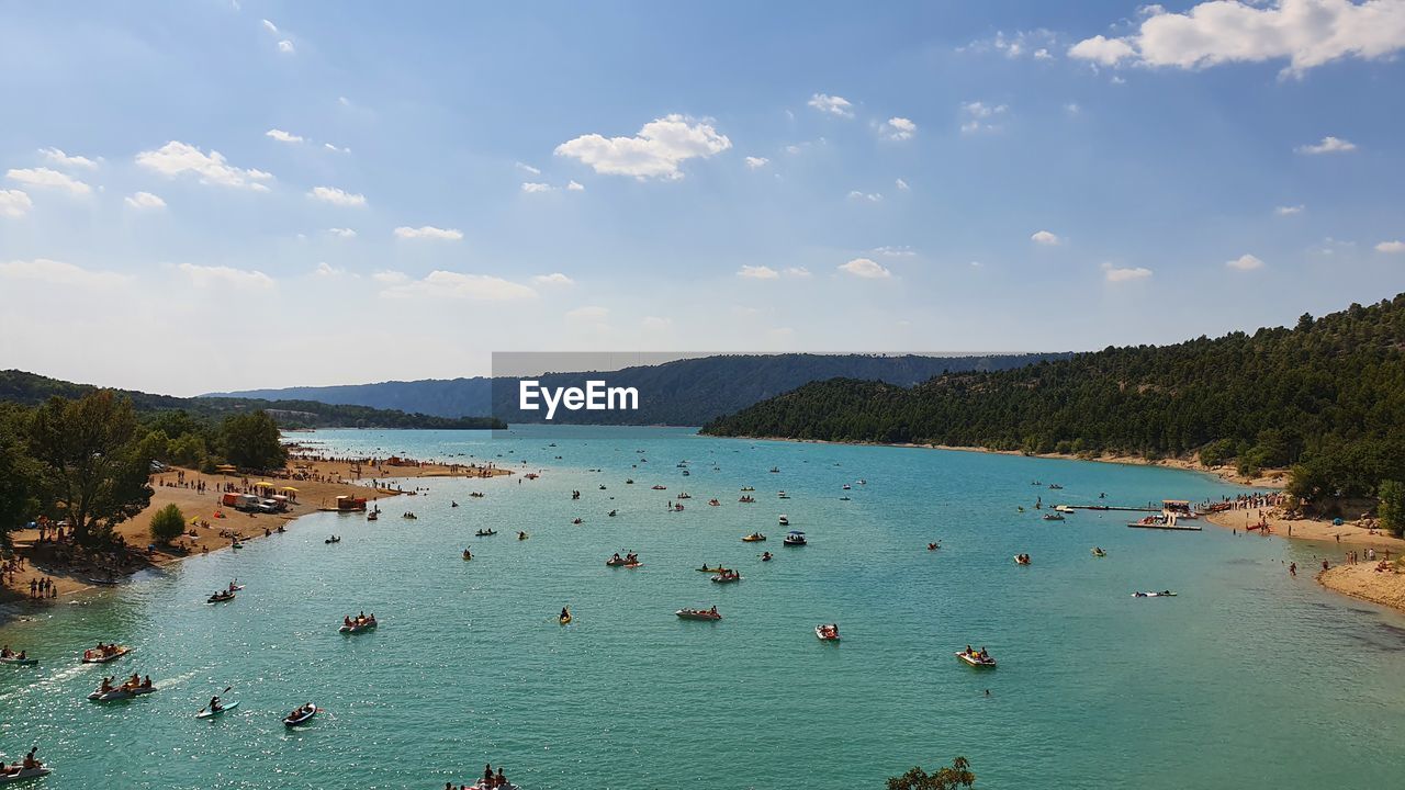 water, sea, sky, body of water, land, scenics - nature, nature, travel, beach, travel destinations, vacation, holiday, trip, shore, nautical vessel, beauty in nature, cloud, tourism, environment, coast, blue, mountain, transportation, coastline, landscape, tree, turquoise colored, bay, tranquility, summer, island, day, outdoors, relaxation, swimming, lagoon, idyllic, tourist, large group of people, crowd, tranquil scene, bay of water, leisure activity, ocean, group of people, high angle view, sand, mode of transportation, plant, non-urban scene, sunlight, sunny, forest