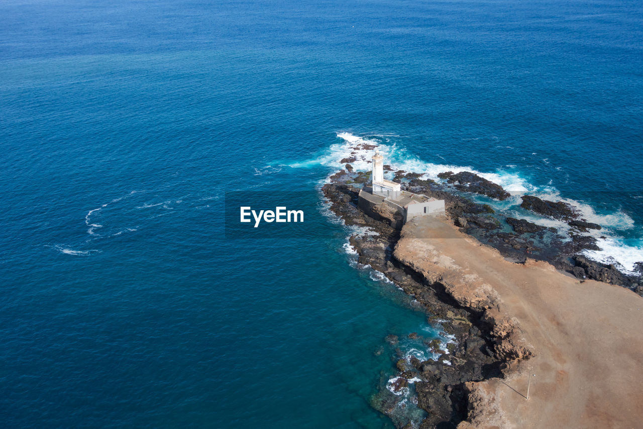 Aerial view of rock formations in sea