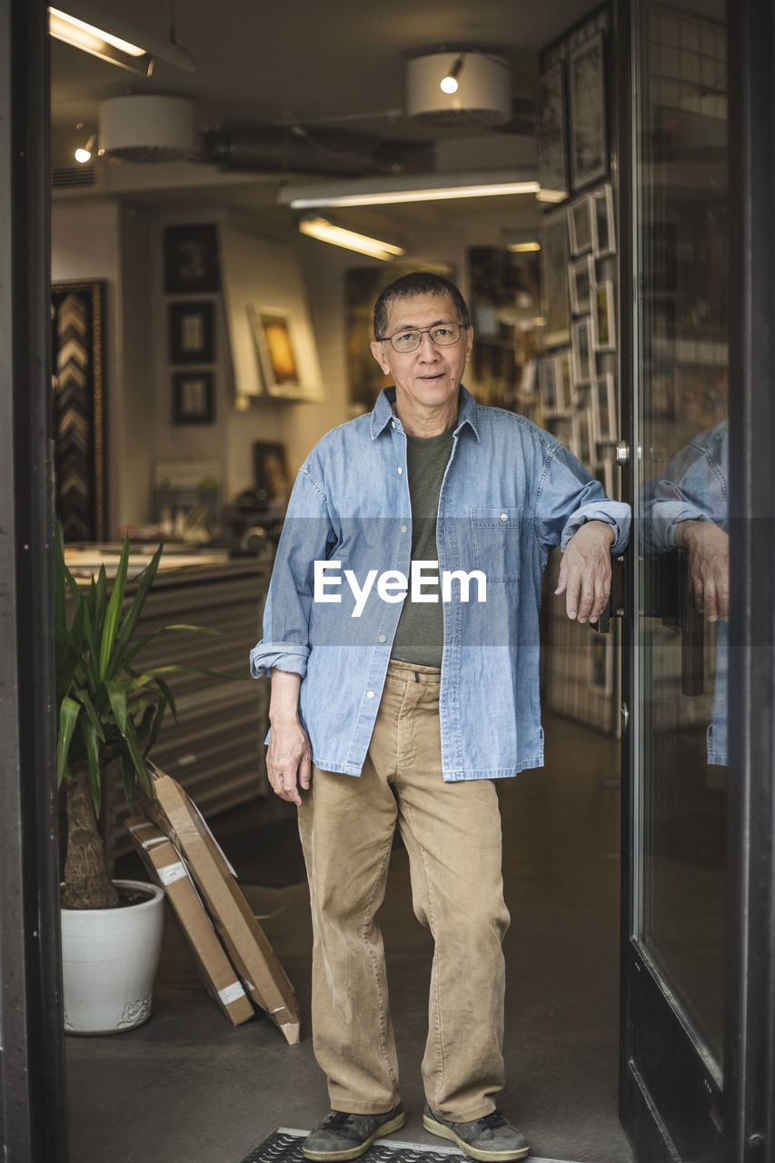 Portrait of senior craftsman at shop