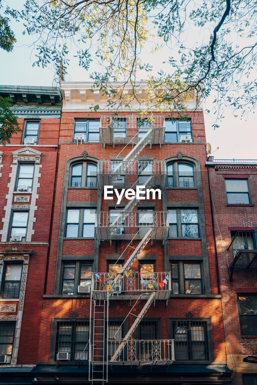Exterior of a typical new york apartment with fire escape at the front, usa.
