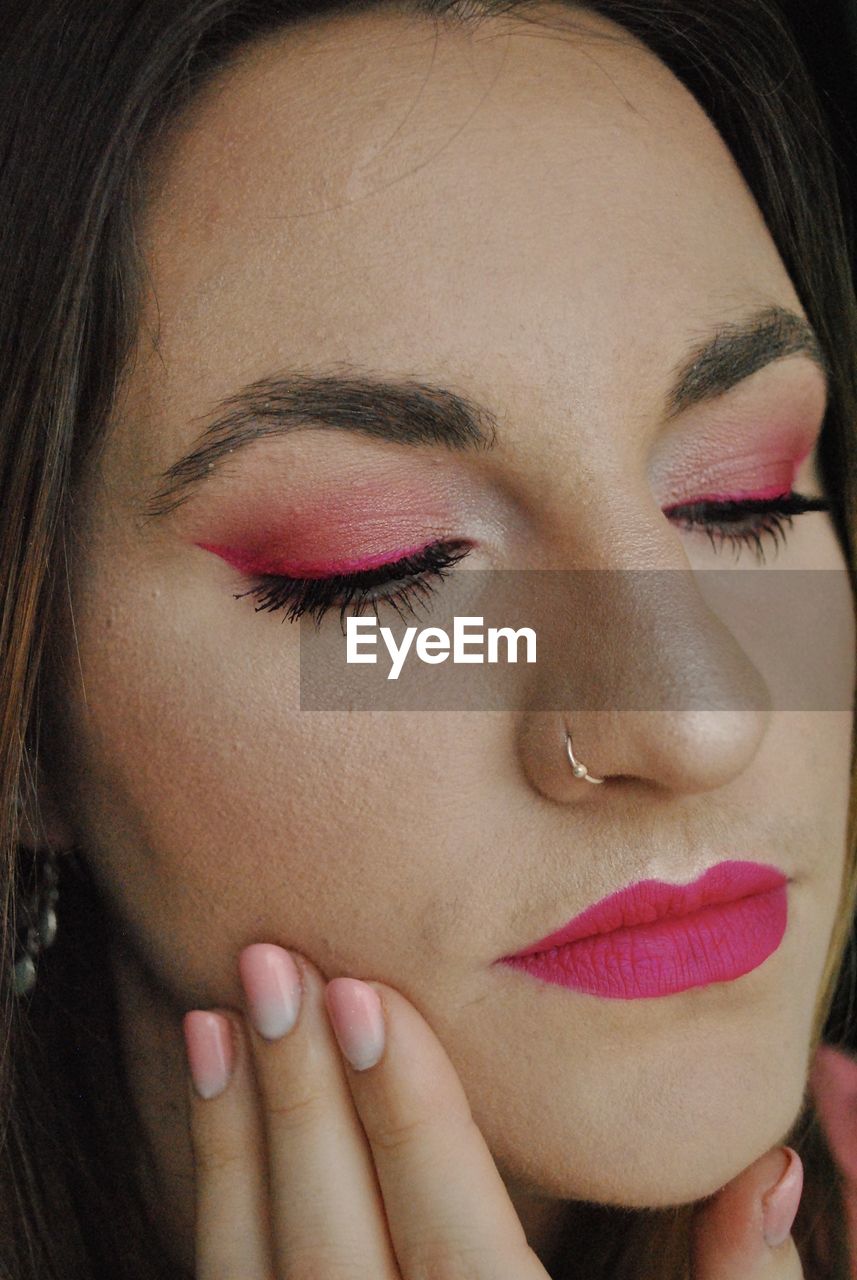 Close-up of beautiful young woman with make-up