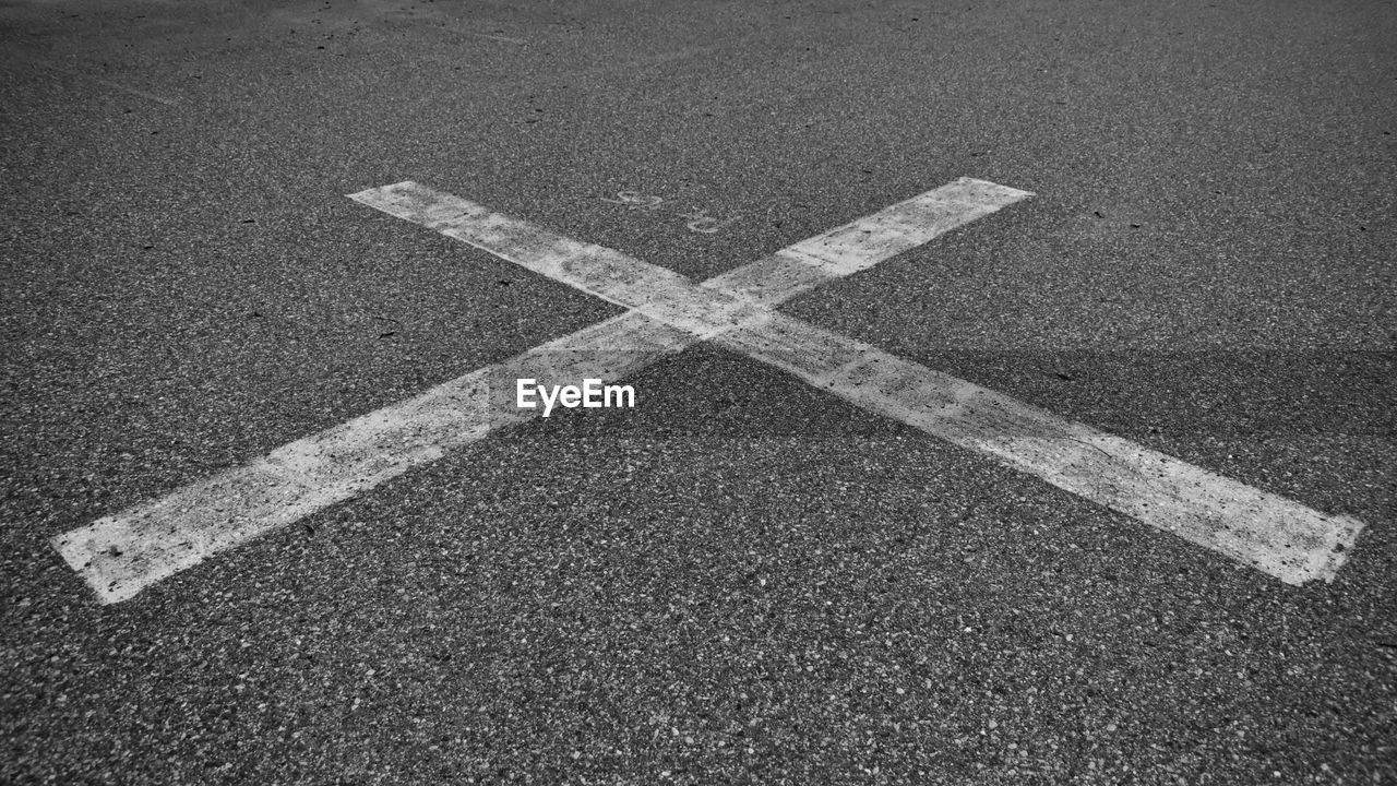 High angle view of cross shape on road