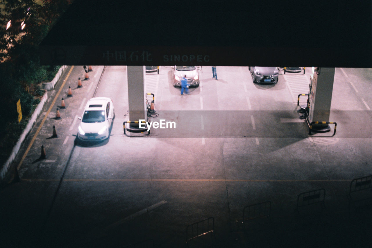 HIGH ANGLE VIEW OF PEOPLE ON ROAD