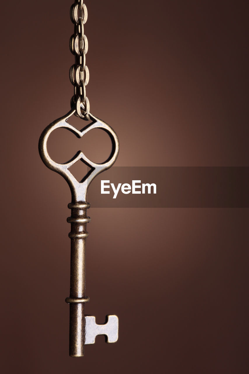 Close up of key against brown background