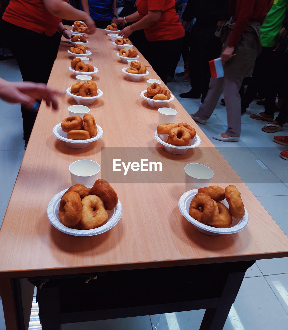 High angle view of people and donuts on table