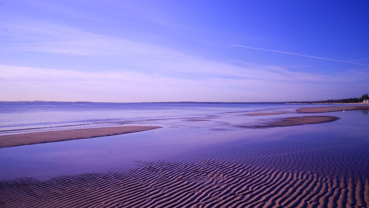 Scenic view of sea against blue sky