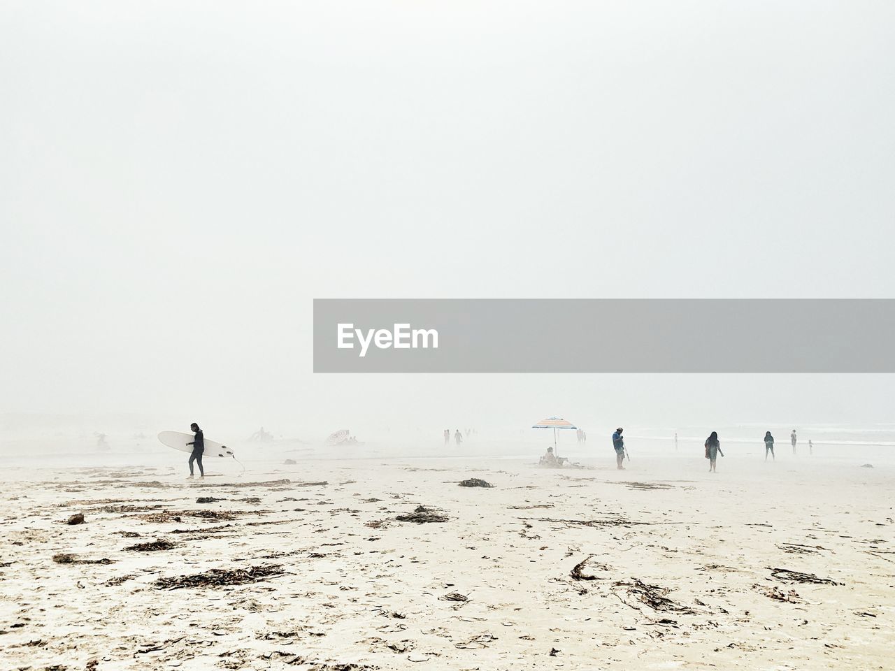 PEOPLE ON BEACH AGAINST SKY