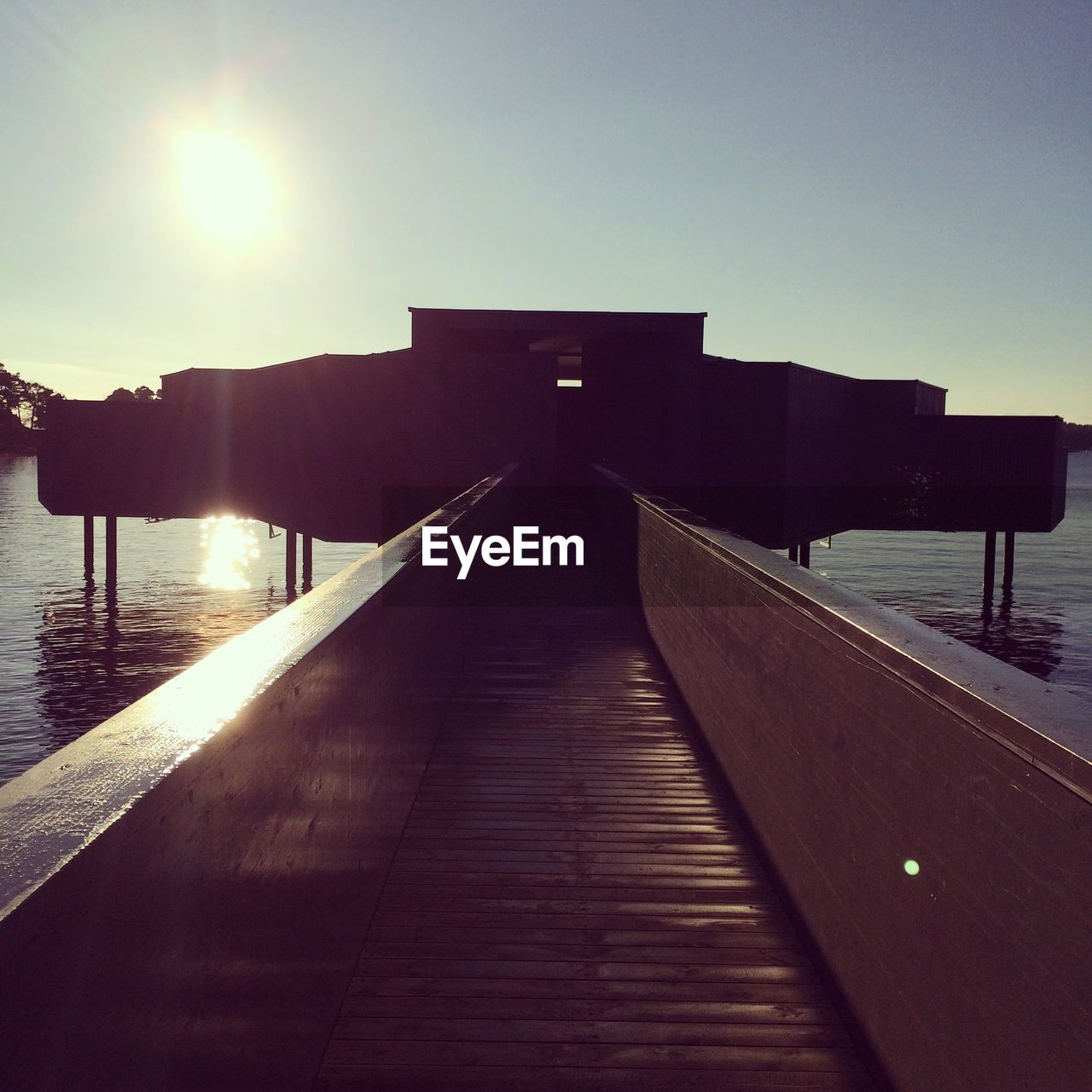 Pier on lake against sky