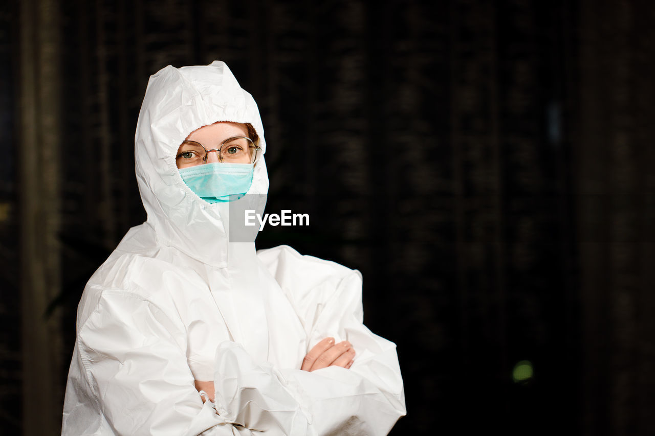 Portrait of woman wearing hazmat suit