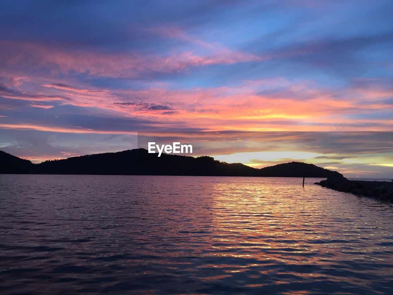 Scenic view of mountains against sky at sunset